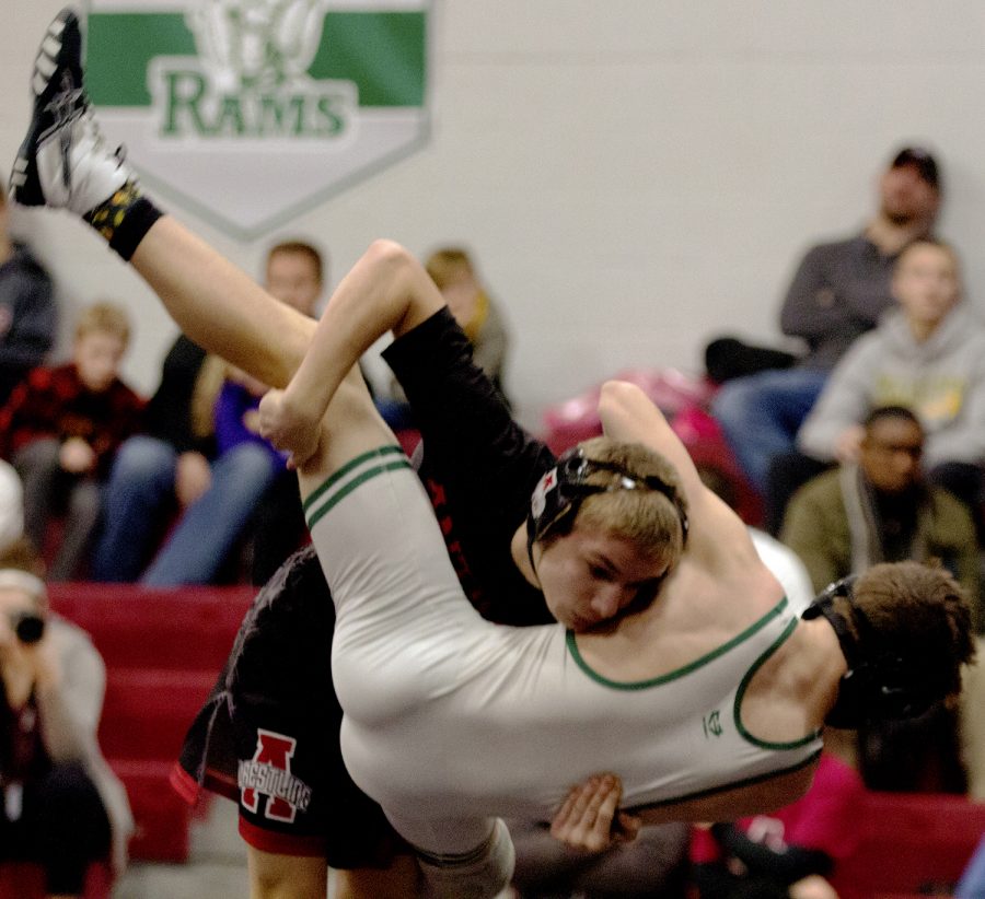 Luke Menzies shoots a double leg takedown to bring his opponent to the mat.