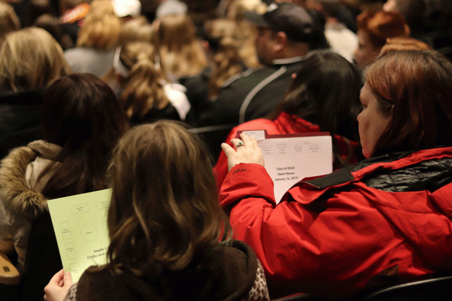 Students and parents look through information  about enrollment at Antioch Community High School.