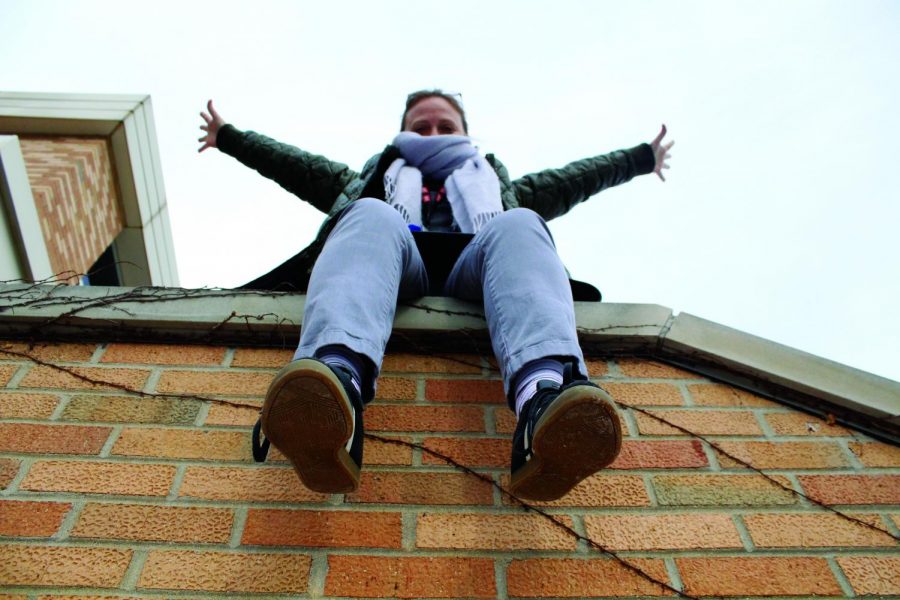English teacher Iwona Awlasewicz hangs off the edge of a wall, just like how she lives life on edge. 
