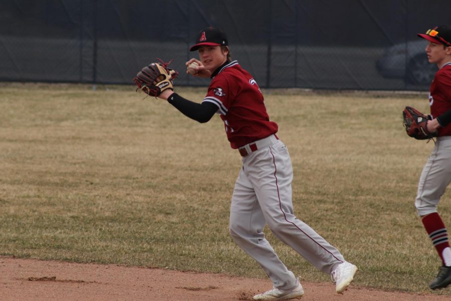 Sophomore+Varsity+Baseball+player+Ethan+Andrews+getting+ready+to+throw+the+ball+to+get+another+out.