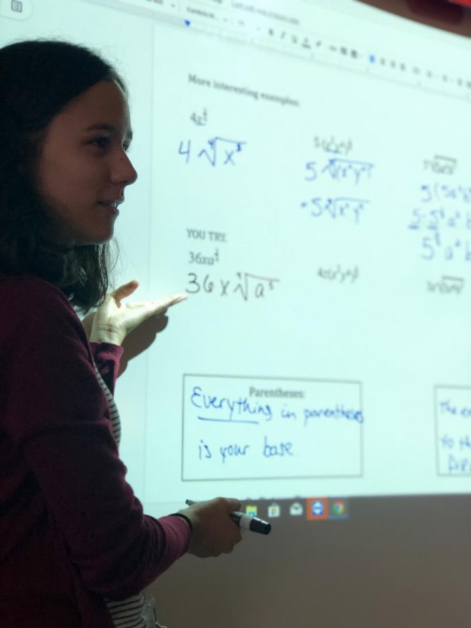 Elisa+Metzger+teaches+her+math+II+honors+students+how+to+simplify+radicals+during+her+fifth+hour+class.+