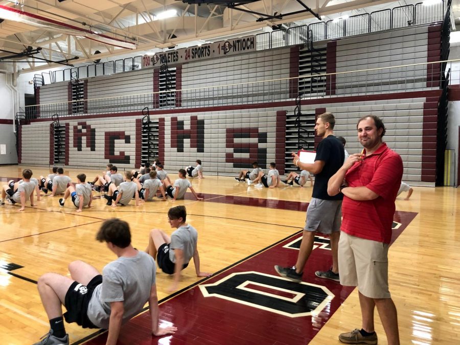 In+his+first+semester+of+teaching+at+Antioch+Community+High+School%2C+Bryn+Nottoli+supervises+a+6th+hour+Boys+Physical+Best+class+as+they+warm-up+before+their+daily+workout.