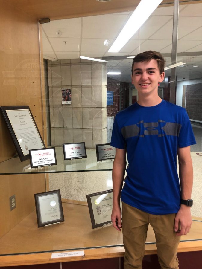 Sophomore Jacob Slaboz stands proudly next to his math teams plaques from last year. When we go to meets, especially conference and regionals, we want to go there and win awards, Head Coach Stanich said. Last year the math team was able to achieve their goal, and hopes to do the same thing this year. 