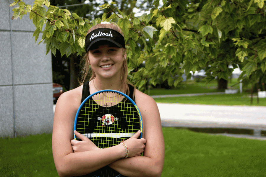 Three sport athlete, Ariana Nikolov, shows of her tennis uniform in preparation for a match.