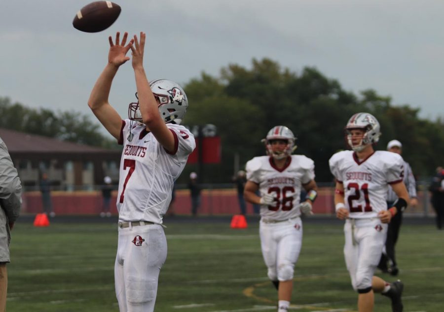 Quarterback Athan Kaliakmanis catches the ball in warmups to prepare for the game.