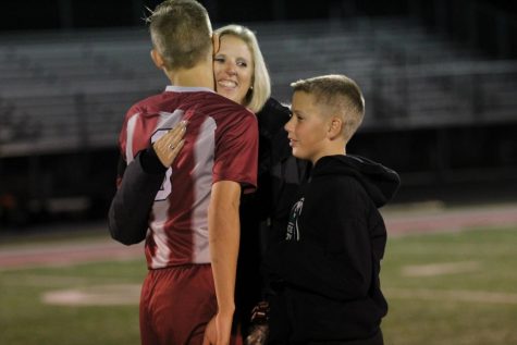 Senior captain Adam Lynn hugs his mom on senior night.