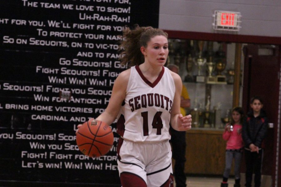 Junior Gianna Riforgiato takes the ball up the court.