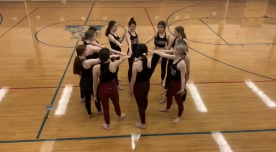 The Antioch varsity dance team huddling up to get ready to raise their energy at practice.
 