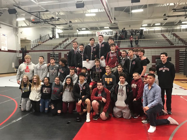The+varsity+wrestling+team+celebrates+their+win+at+the+Lake+County+Invitational.