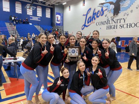 The dance team poses with their trophy after being crowned conference champions. 