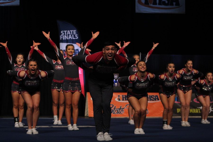 Starting their choreographed dance, senior Paul Valdivia-Valencia gives it his all at  the IHSA varsity cheerleading state championship.