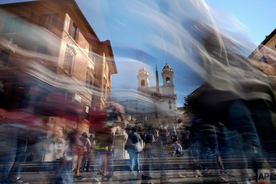 In this photo made with a long exposure, people walk by the Spanish Steps in Rome. This can resemble how life may feel when a gap year is taken, time has the potential to pass by quickly 