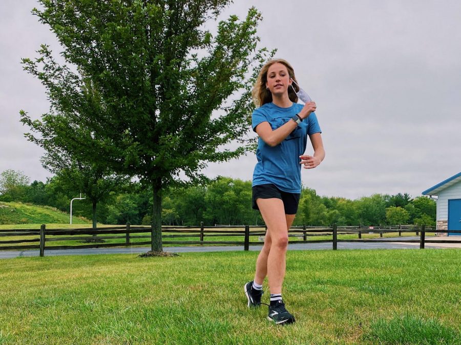 With current situations, high school sports are required to wear face masks while they play their sport. Junior Alexa Philips struggles to proceed with full effort while wearing a mask.