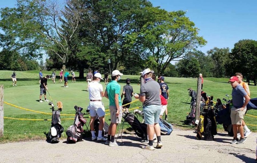 The boys golf team practicing their putts and chips; in preparation for a day of golf.