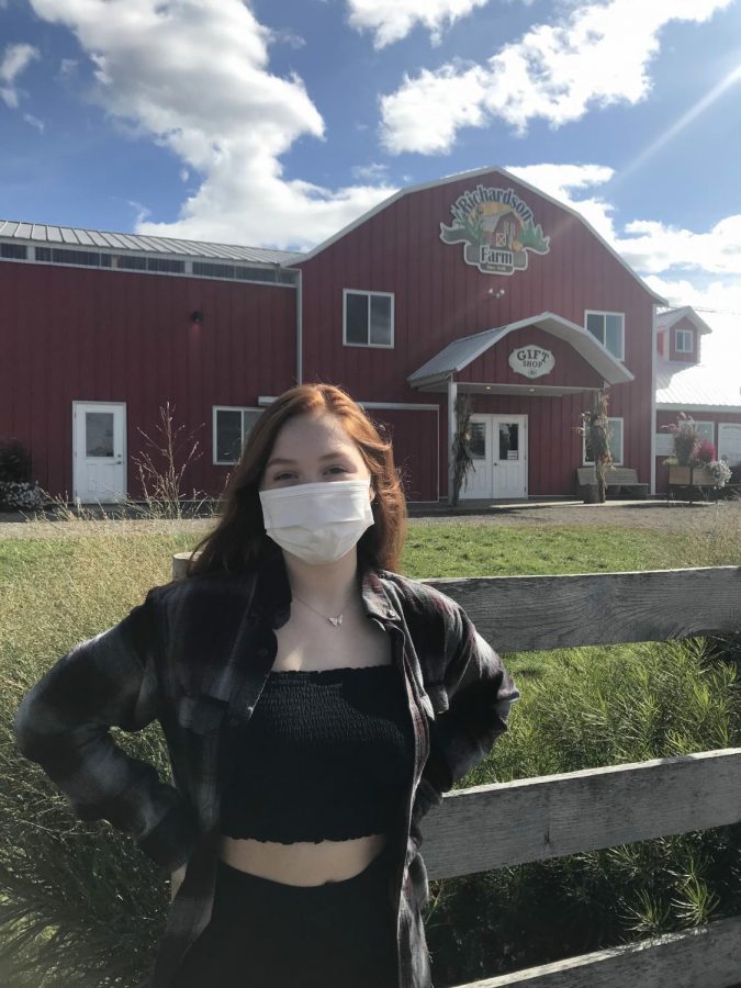 Sophomore Carissa Lozano standing in front of Richardsons Farm while abiding to new safety precautions. 