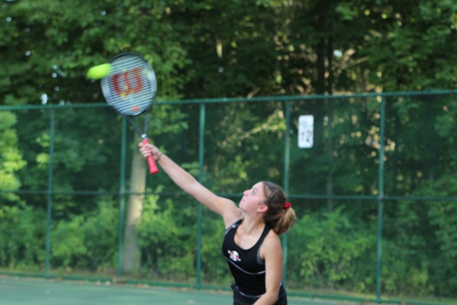 Junior Paige Wilson serves in the Sequoits dominant first match of the season.