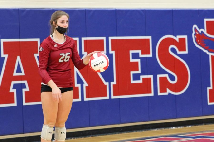 Senior Ana Marcell prepares to serve the ball to lakes.