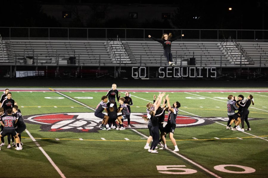 Senior cheerleader Bella Bussone flies during the guy-girl dance at the 2021 Homecoming pep assembly.