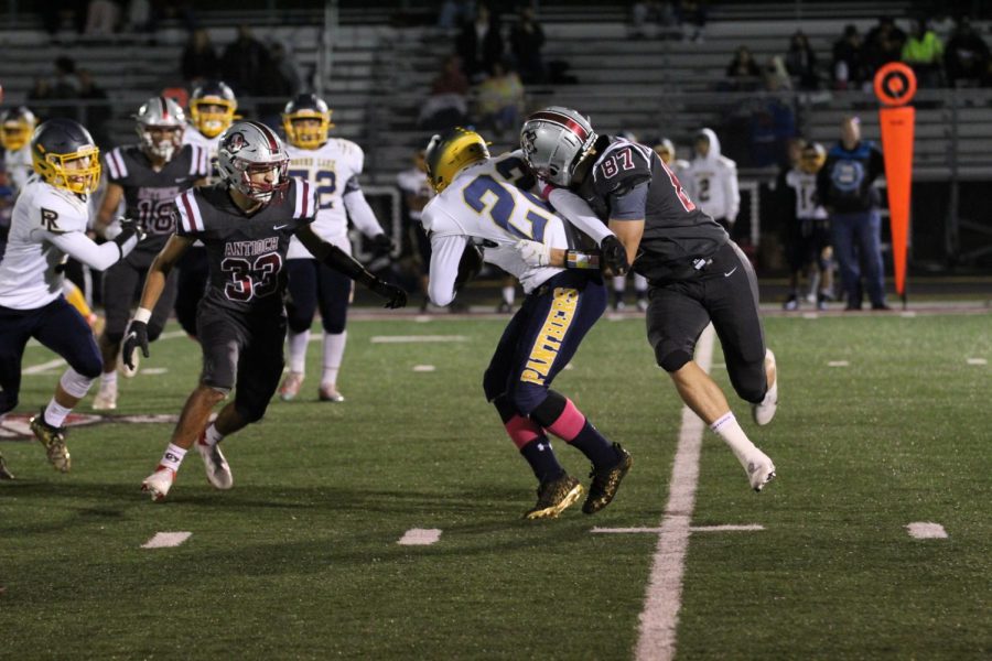 Junior Joey Neumann tackles Round Lake player in Sequoits homecoming game.