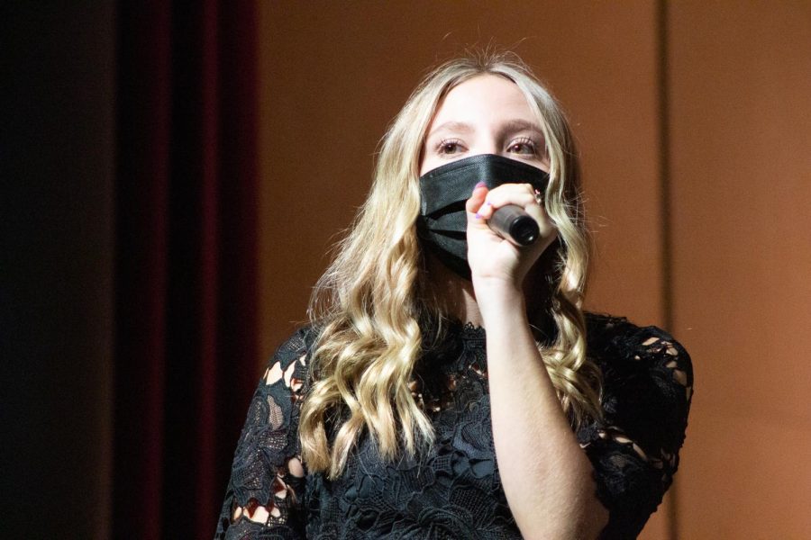 Hadde Luebke looks out to the audience as she performs for her first choir concert of senior year.