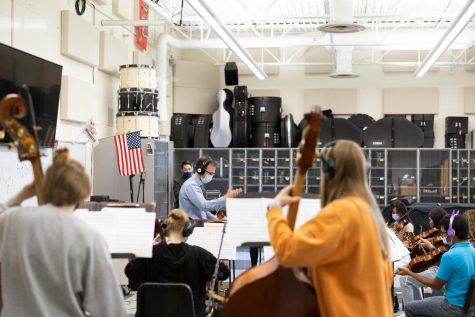 Orchestra director Michael Riggs directs the orchestra as they take advantage of their studio-quality recording equipment.