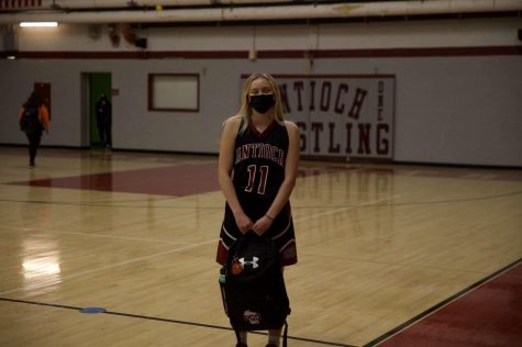 Callie Bemis getting ready to go to basketball with her bag.