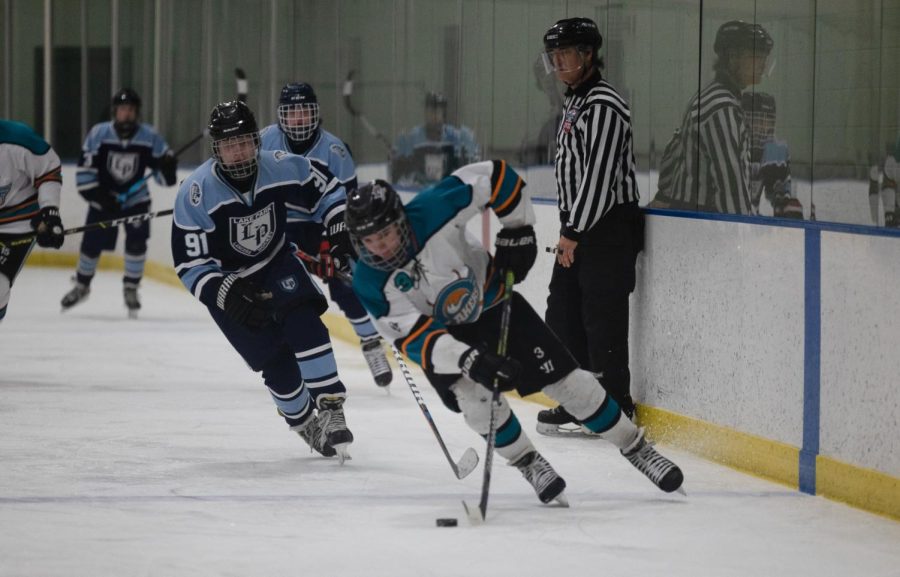 Senior Gavin Frank skates with the puck. 