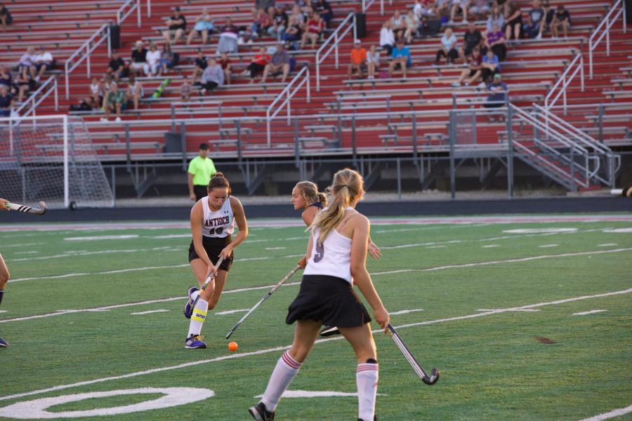 Senior Cameron Pluciennik loose dribbles toward the outside of the field.