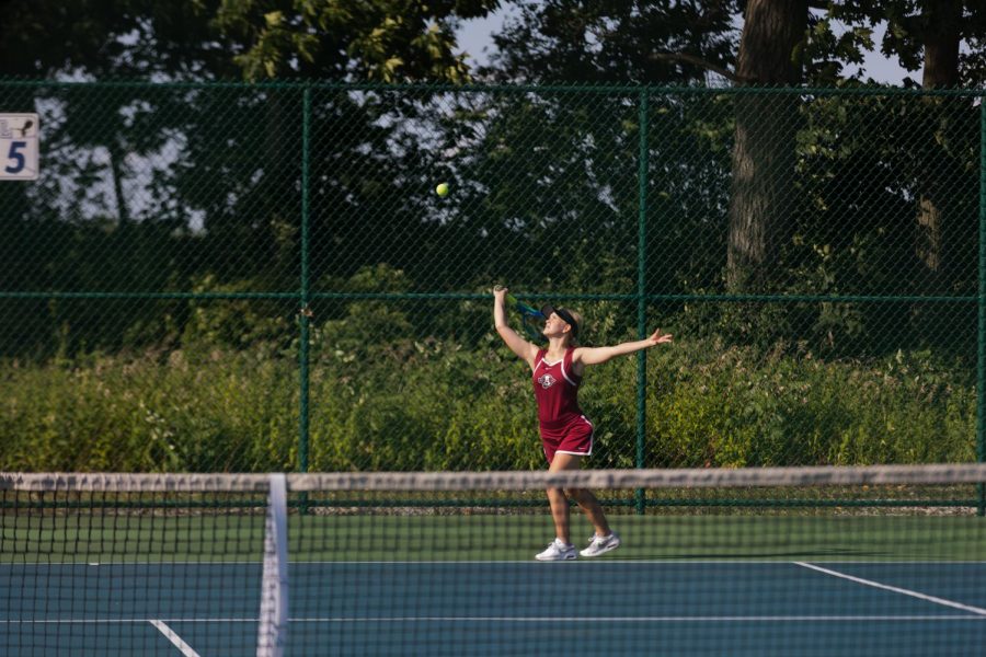 Sophmore+Avina+Doty+serving+in+her+tennis+match+against+Lakes.