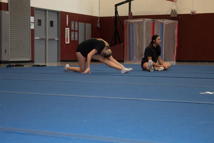 Junior Katie Decremer stretching at practice.