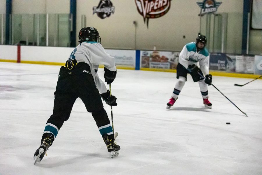 Players on the Lakers hockey team practicing their passing skills.