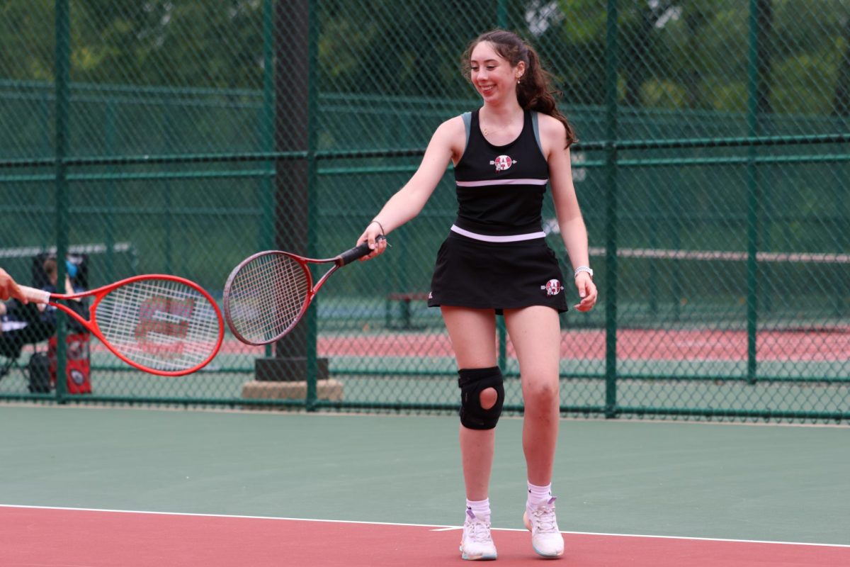 Senior Larkin Murphy playing doubles at D117 Cardinal Courts.