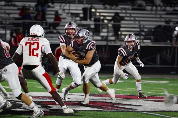 Senior running back Nick Day receiving a hand-off from senior quarterback and long-time friend, James Sheehan.