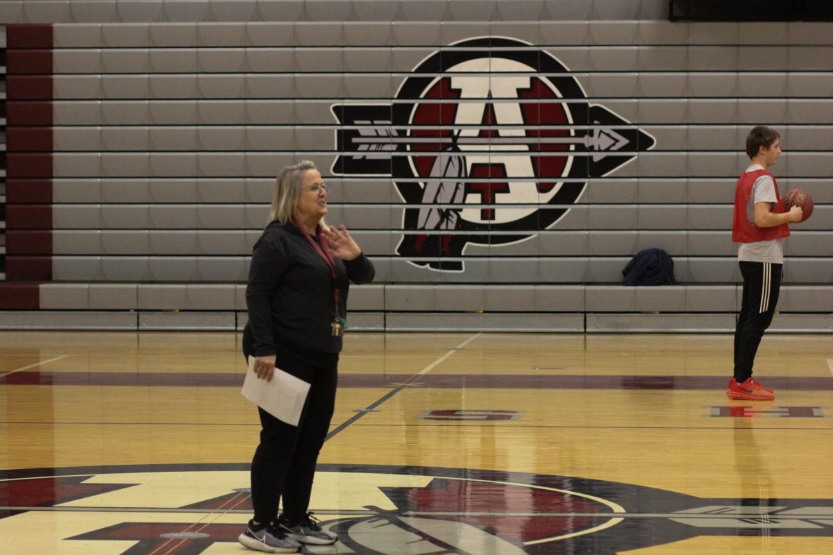 Physical Education teacher Heather Coleman coaches a gym class starting a new game.
